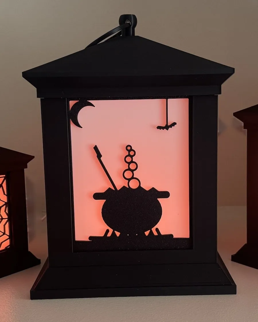Lantern with a cauldron silhouette glowing orange